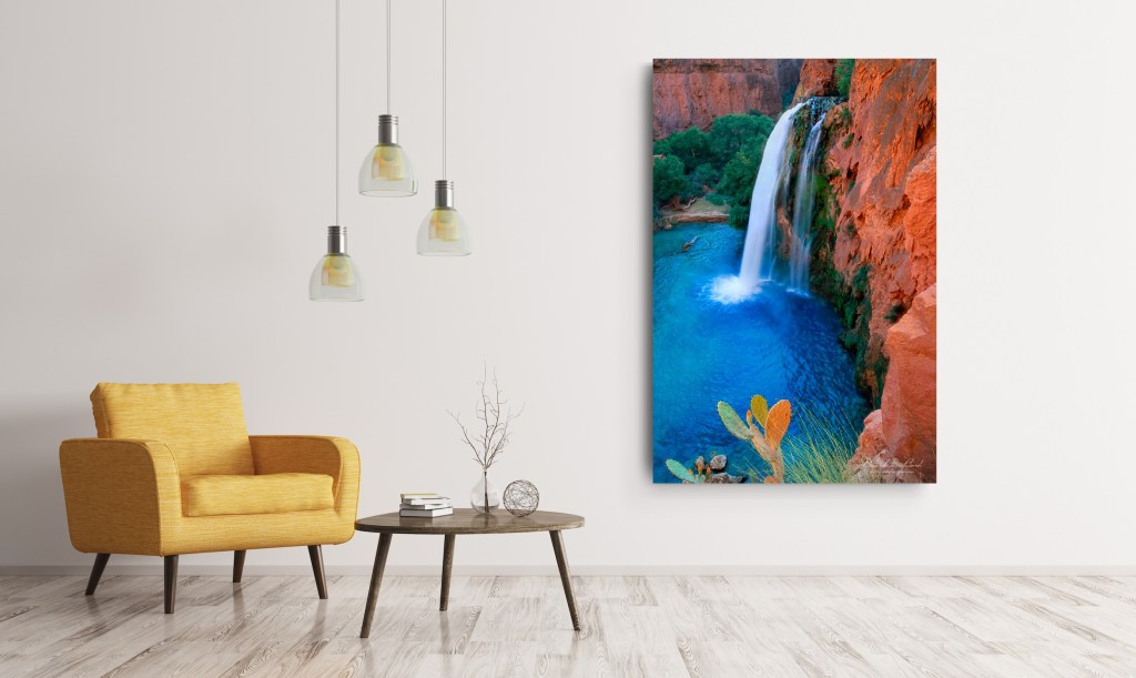 A beautiful fine art nature photograph print of waterfalls in Grand Canyon in a home with a yellow couch