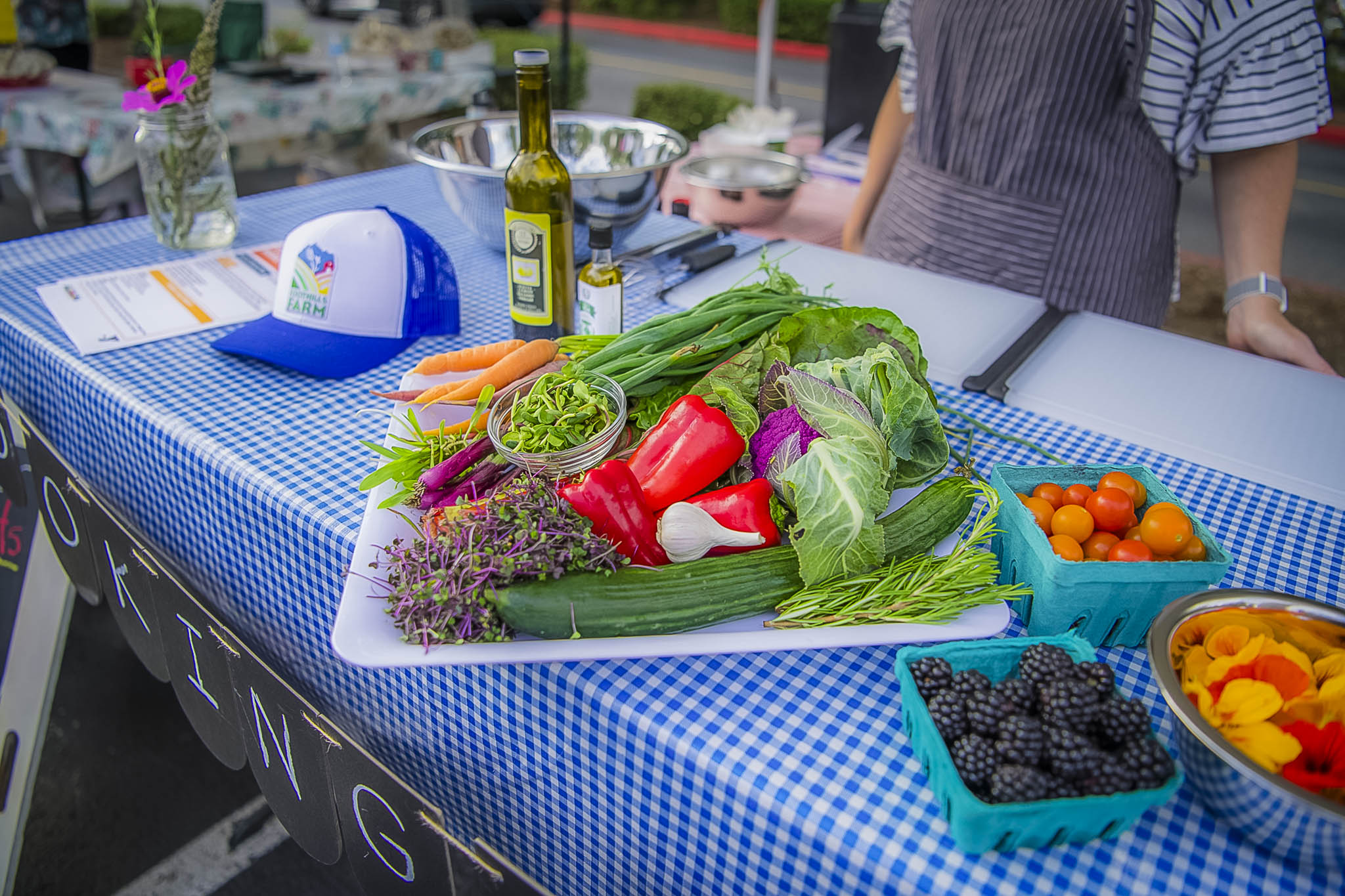 Demonstration of ingredients used for cooking at a farmer market. Cooking demonstration. Commercial photography by Kiss of Heaven Photography.