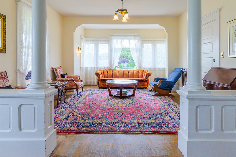 An interior of an antique home with vintage or antique furniture and red carpet in Yakima Valley, WA. Real estate photography service by Kiss of Heven Photography.