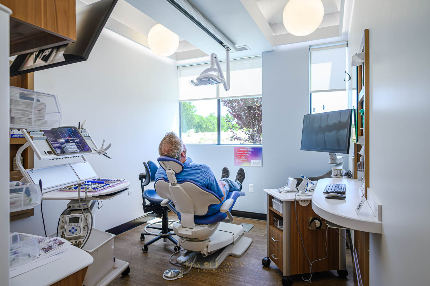 A patient sitting on dental chair designed ergonomic by Designed Ergnomic, Inc. Commercial photographer by Kiss of Heaven Photography.